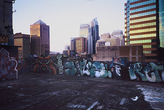 Graffiti-covered rooftop at Hibernian House in Surry Hills overlooking Sydney city skyline