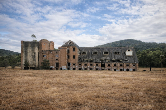 Historic red-brick malthouse buildings of the Mittagong Maltings seen from the park