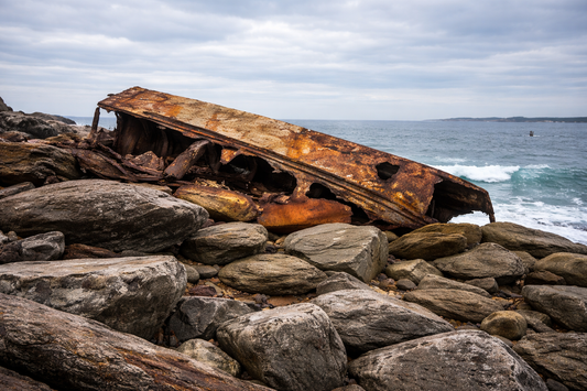 Rusted iron remains of the SS Minmi shipwreck on the rocks at Cape Banks La Perouse