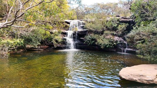 Curracurrang Falls waterfall cascading into swimming hole in Royal National Park