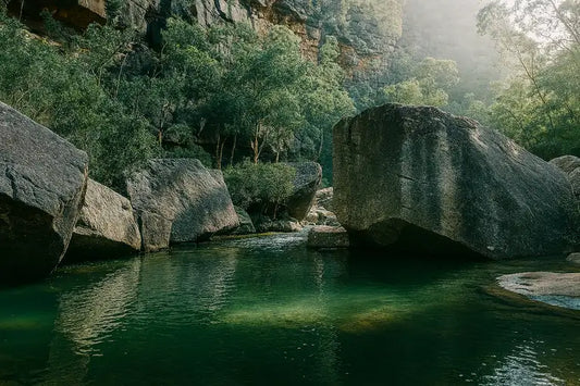 Deep, still swimming hole on Erskine Creek framed by large sandstone boulders in Blue Mountains National Park