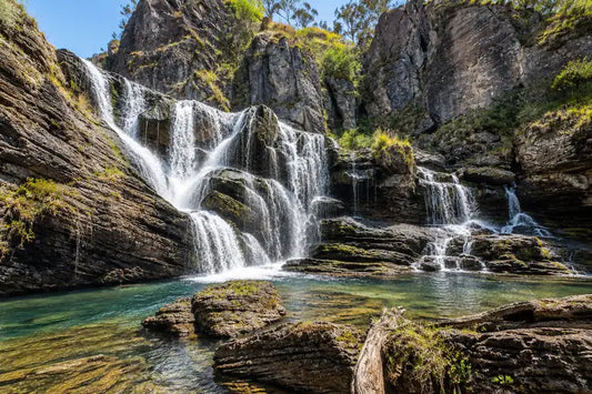 Cooleman Falls dropping over a limestone cliff into a blue-green plunge pool at the end of Clarke Gorge, Kosciuszko National Park