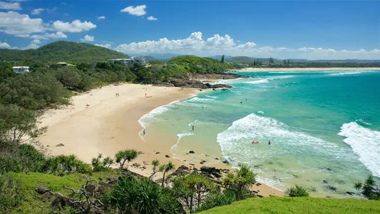 Turquoise waves rolling onto Cabarita Beach below the green slopes of Norries Headland on the Tweed Coast