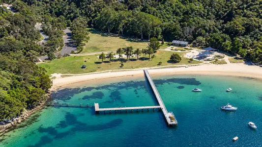 The long timber jetty at Clifton Gardens stretching into calm water on Chowder Bay, Mosman
