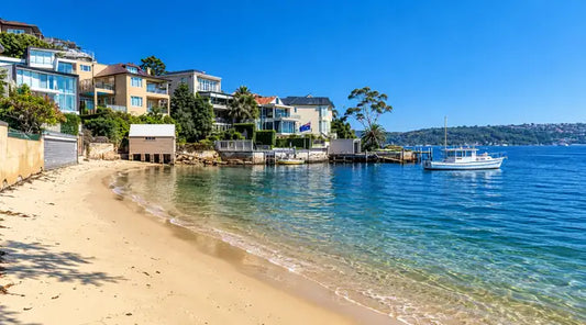 Calm water and a narrow strip of sand at Lady Martins Beach on Felix Bay, Point Piper