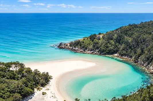 Crystal-clear turquoise water over a rippled sandy bottom in Korogoro Creek at Hat Head