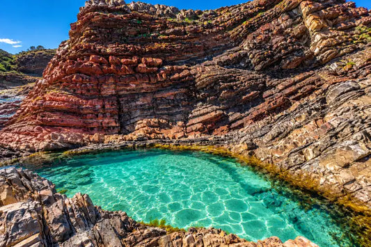 Turquoise rockpool on an elevated rock shelf beneath a cliff near Back Beach, Crescent Head