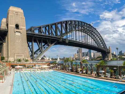 The outdoor 50-metre pool at North Sydney Olympic Pool beneath the arch of the Sydney Harbour Bridge