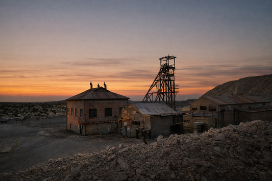 The rusted steel Miners Memorial on the Line of Lode at sunset Broken Hill